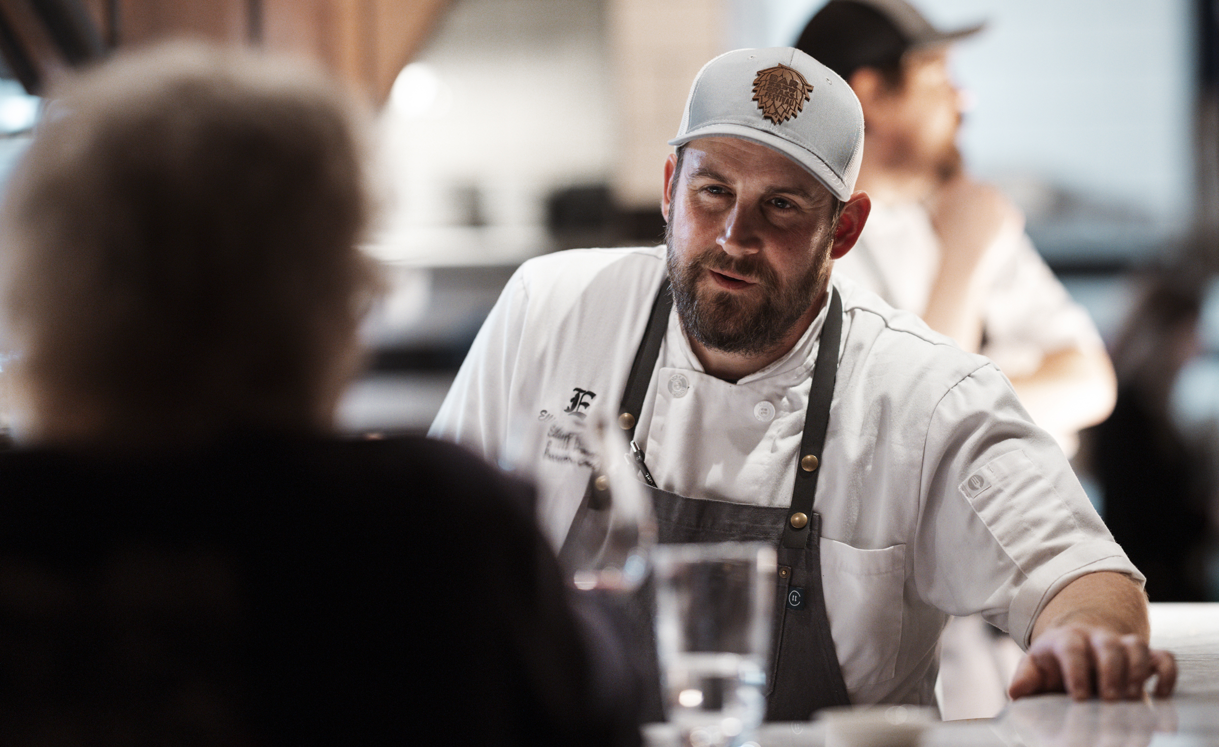 Guests seated at The Establishment's Chef's Counter watching the open kitchen in action